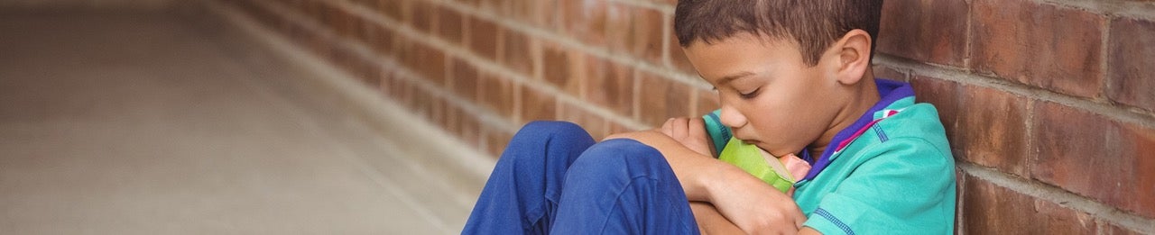 A child sits in sadness