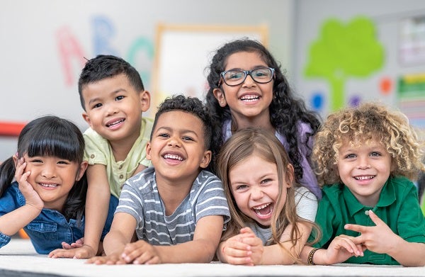 A group of grade schoolers sitting together at a table