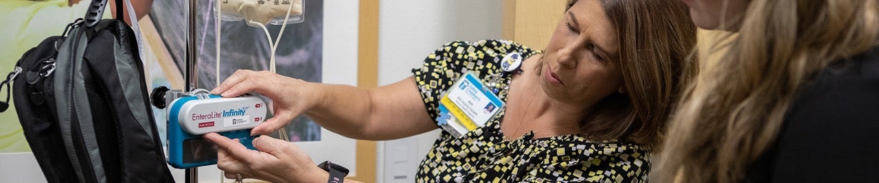 A woman shows how to use an instrument