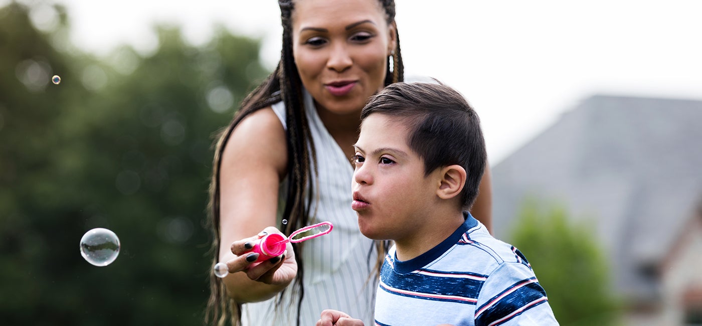 Mother and child blowing bubbles
