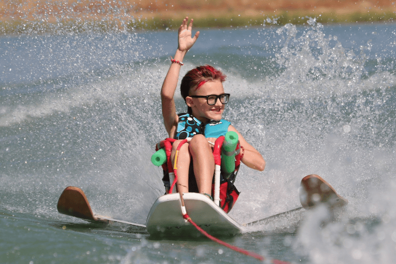 A young participant enjoys an Adaptive Sports water ski clinic