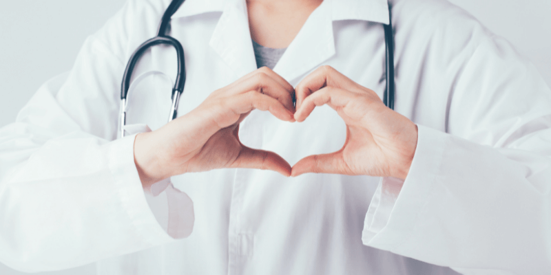 Medical working making a heart with their hands