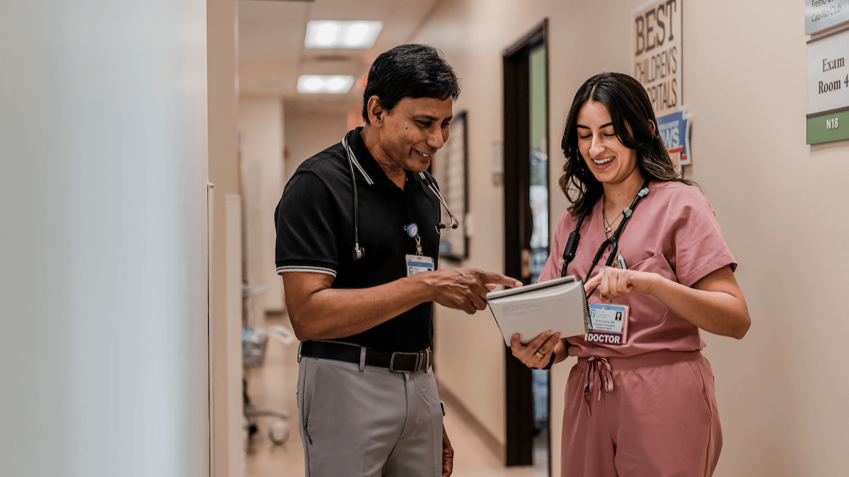 Two physicians reviewing a document together