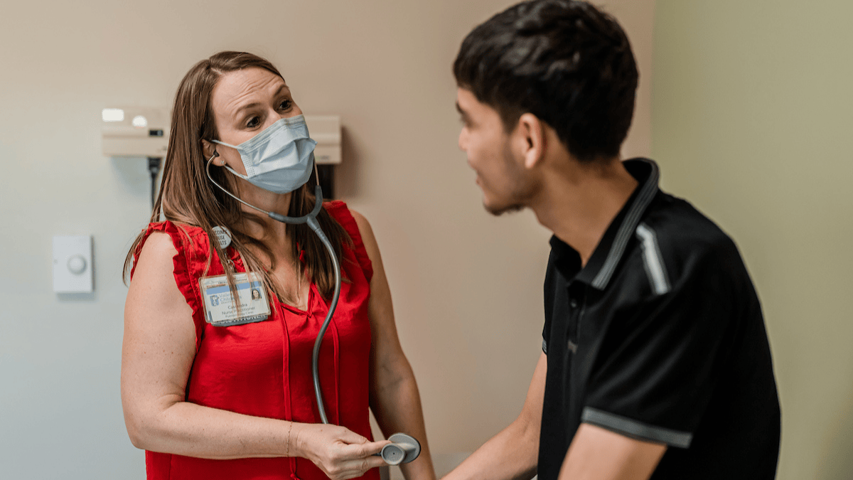 A nurse practitioner consults with a patient