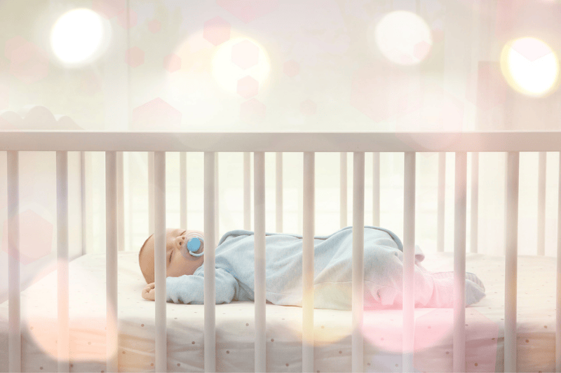 A baby sleeps in its crib