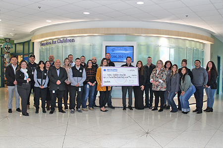 U.S. Cold Storage Employees Stand behind an oversized check