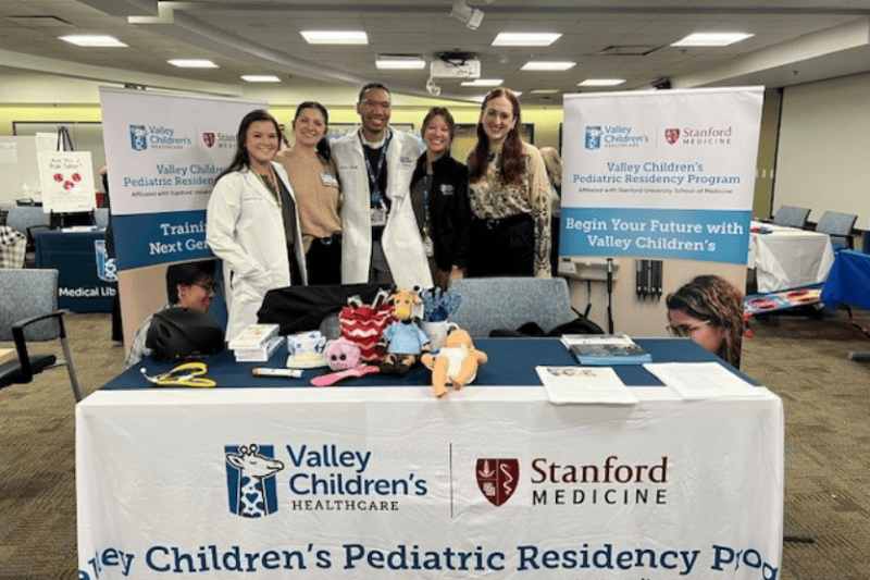 Valley Children's pediatric residents smile at a health fair booth