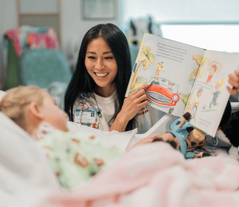 A Valley Children's Child Life Specialist reads to a young patient