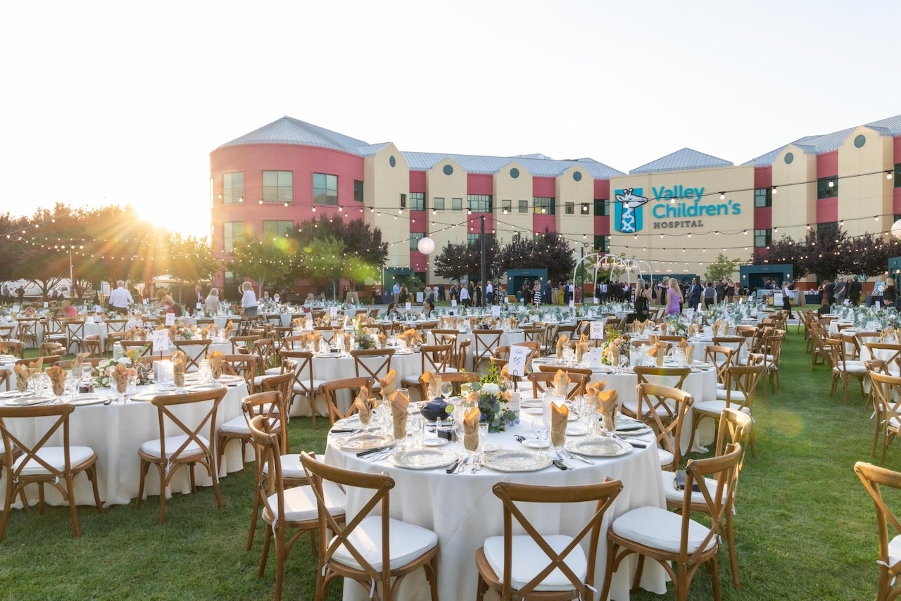 wide view of tables and chairs decorated for the event