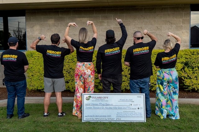 Group of Extra Life Gamers show off their shirts