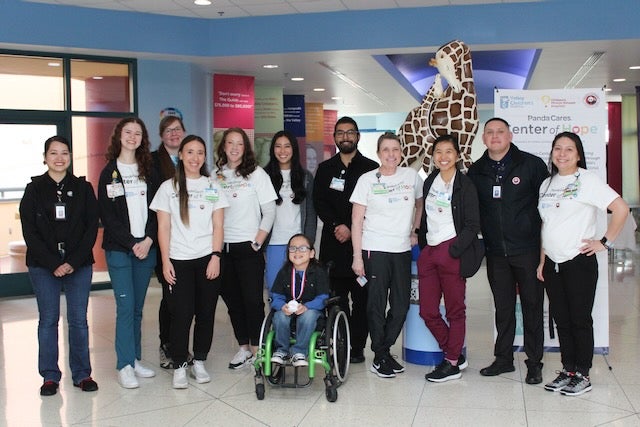 The Child Life Services team poses with Panda Cares Center of Hope shirts on