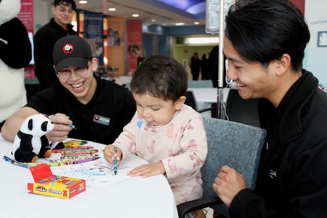 Panda Express employees draw with a patient