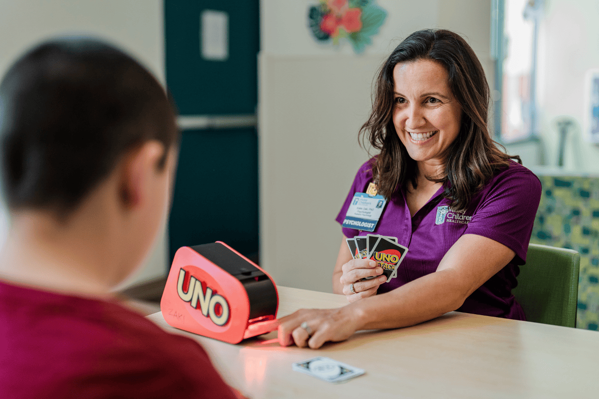 Valley Children's psychologist Dr. Katie Zaki plays Uno with a patient