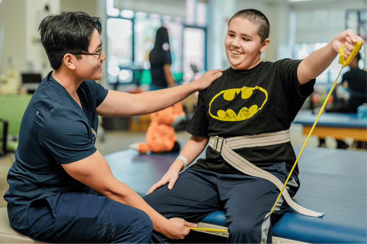 A Valley Children's Rehab aide works with a patient