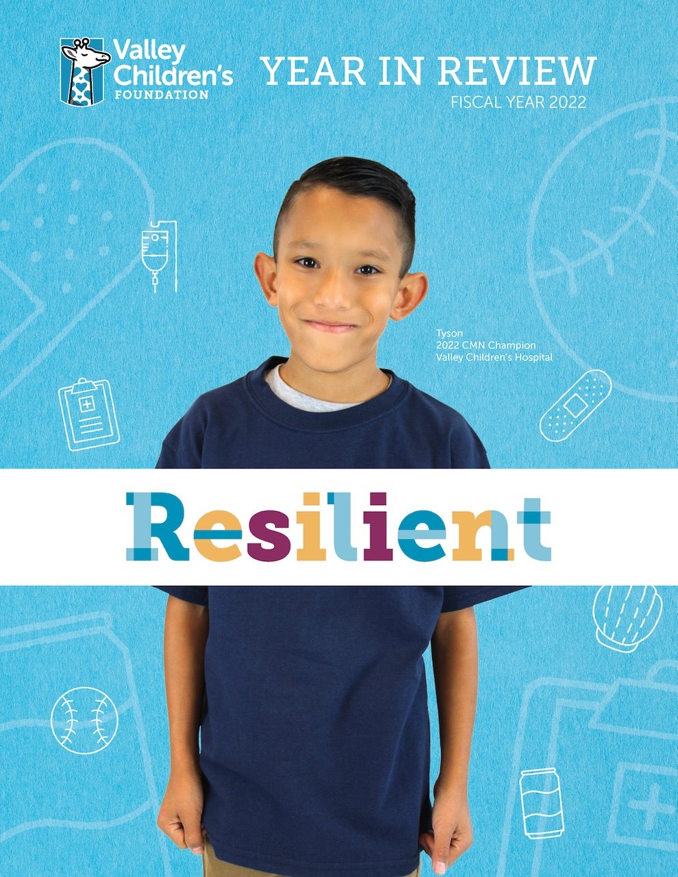 A young boy smiles with the words "Resilient" in front of him