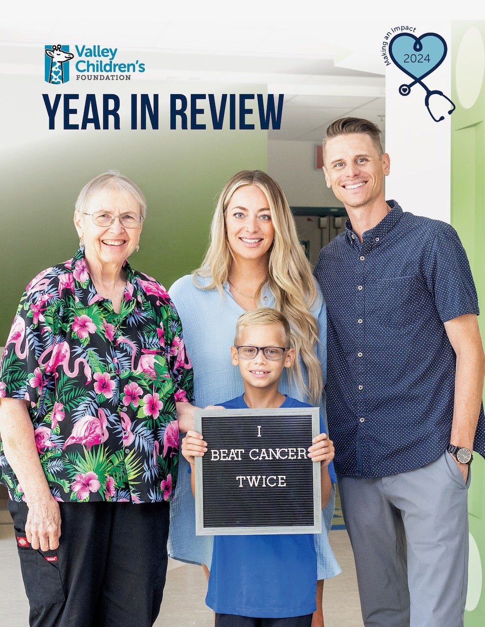 Family stands with a doctor. Child holds a sign that says, "I beat cancer twice."