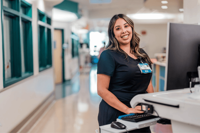 A Valley Children's nurse smiles at her work station