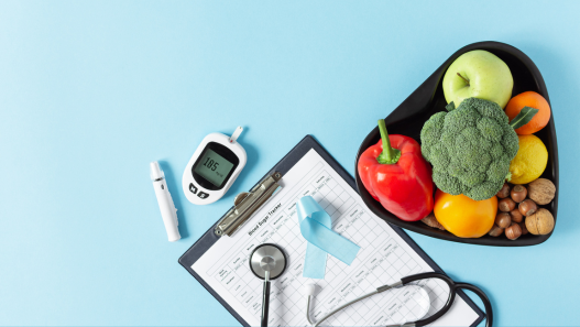 clipboard next to a bowl of vegetables and fruits