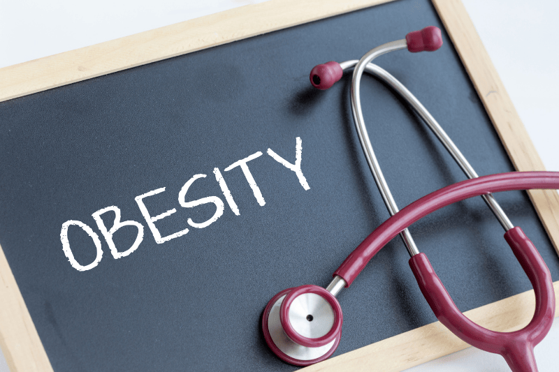 Chalkboard that reads obesity with stethoscope