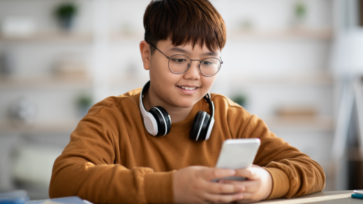 Young Teen smiling looking at phone