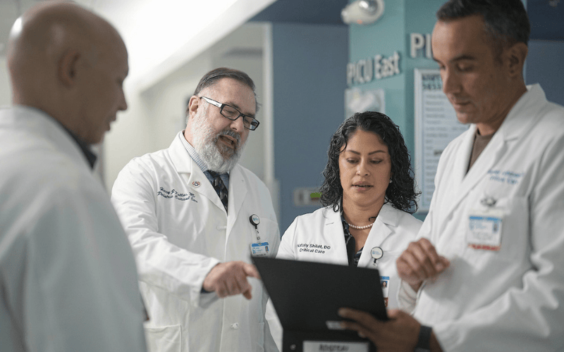 Four physicians consult on a case