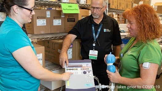 Valley Children's Home Care respiratory therapists examining machine