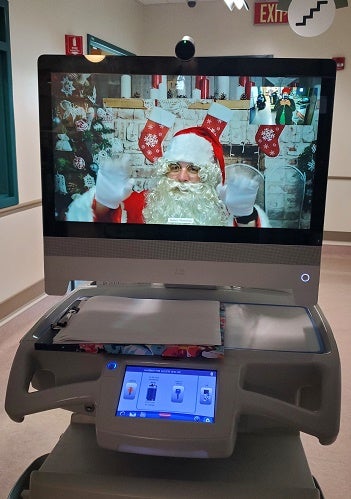 Virtual Santa on portable cart screen