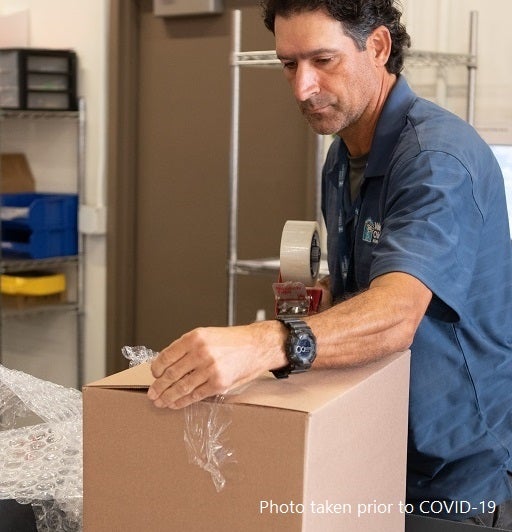 Valley Children's Home Care distribution center employee preparing a package for delivery