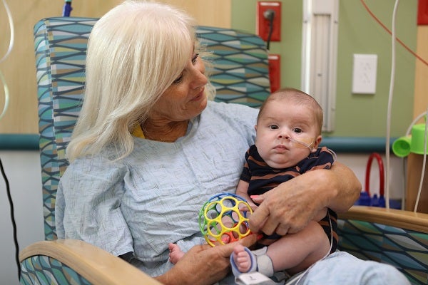 Valley Children's volunteer Jill cradles a baby