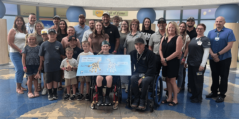 Luke presents a donation check at Valley Children's Hospital